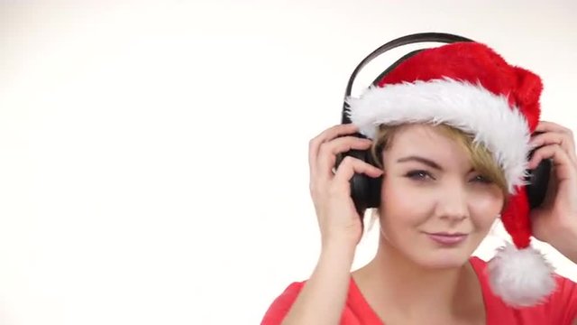 Woman in santa hat listening music. Chirstmas 4K