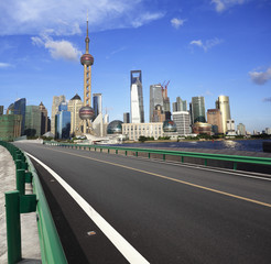 Fototapeta na wymiar Empty road surface with shanghai bund city buildings
