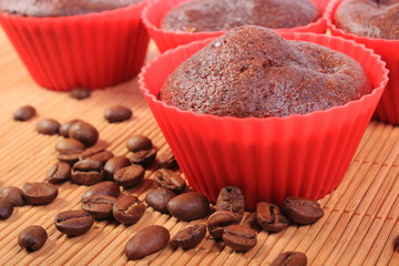 Fresh baked chocolate muffins and coffee grains