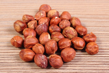 Heap of brown hazelnut on wooden table
