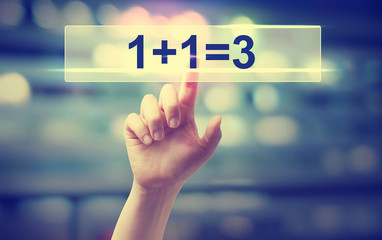1+1=3 concept with hand pressing a button