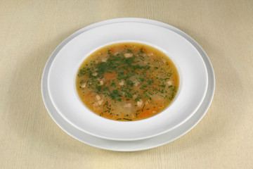 fish soup in white plate on the table