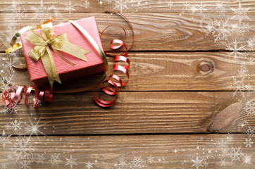 Christmas presents with snow crystal on wooden table background.