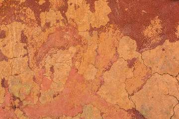 Red grunge wall surface. Cracked concrete texture closeup backgr