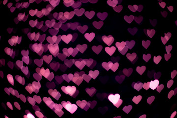 Pink heart bokeh in the dark.