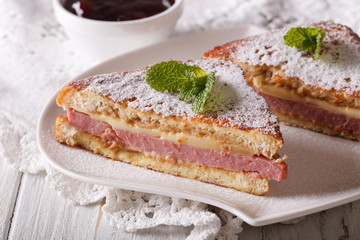 Monte Cristo sandwich with powdered sugar closeup. horizontal
