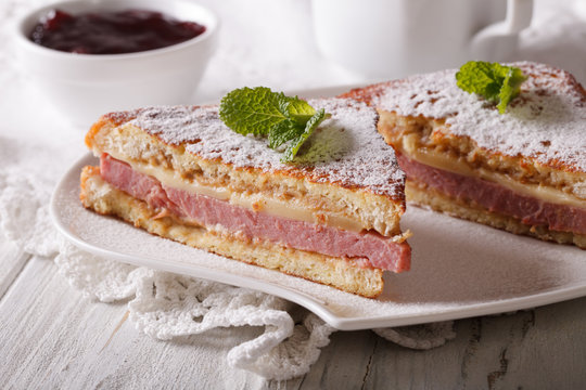 Sandwich of Monte Cristo close-up on a plate and berry jam.
