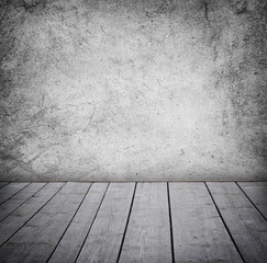 Grunge wall and wood paneled floor, interior of a room.