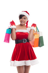 asian woman in red santa costume with colorful shopping bags