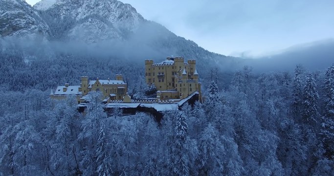 Aerial view of Hohenschwangau Castle at sunrise in winter landscape