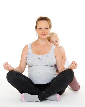 Pregnant woman with daughter. Fitness.