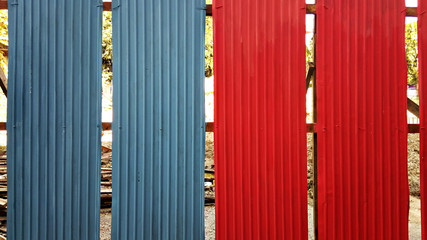 Blue and red galvanized iron plate fence