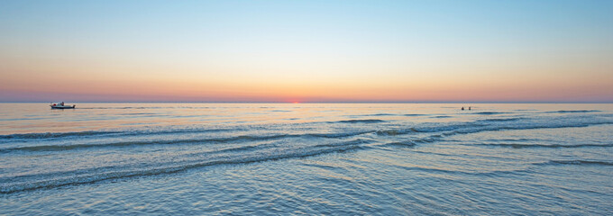 Sunset over a motor boat in sea in summer 