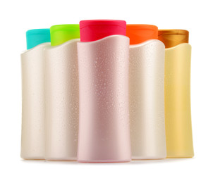 Plastic bottles of body care and beauty products over white