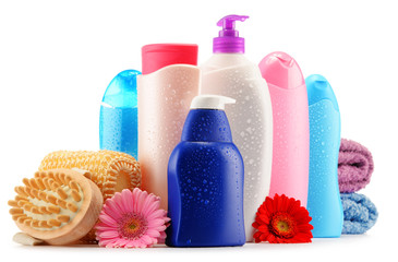 Plastic bottles of body care and beauty products over white