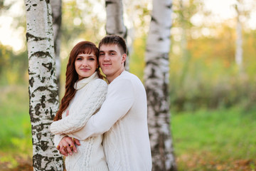 Fototapeta premium love, happy couple in park with birch trees, summer, autumn suns