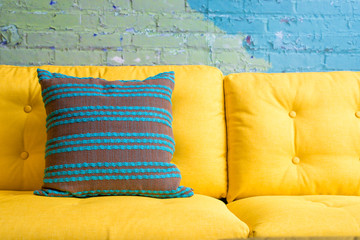 stripe green pillow on vivid yellow sofa