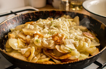 Fried potato on pan in real kitchen