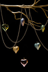 Hanging colorful Christmas balls on black background