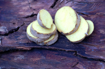 Potato on wooden background
