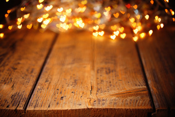 Background with heart shaped lights on rustic wood 