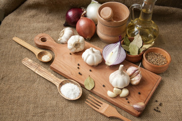 Fototapeta na wymiar Garlic, onion, coriander, sesame seeds, black pepper, bay leaf, sea salt, olive oil,