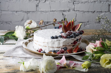 Romantic Cake with white cream and summer berries and figs.