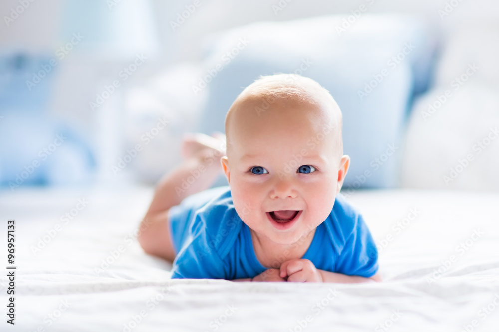 Wall mural baby boy in white sunny bedroom