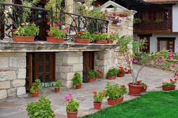 Obraz premium Natural Stone Landscaping In The Backyard With Many Flowerpots