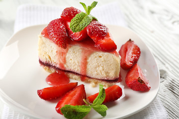 Delicious cheesecake with berries on table close up