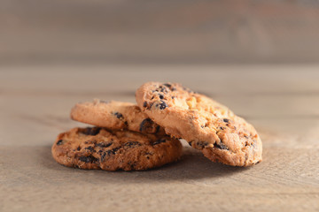 Cookies with chocolate crumbs on wooden background