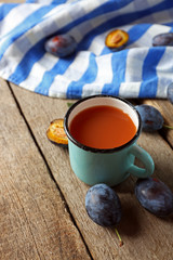 Plum Juice in a mug with fresh fruits
