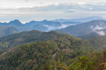 Fototapeta premium Top view of the mountains, the valley, the road and the forest o