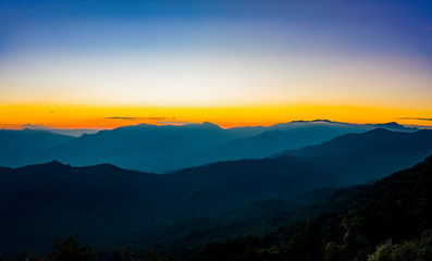 Fototapeta na wymiar Sunset in the mountains landscape with sunny at Doi Pha Hom Pok,