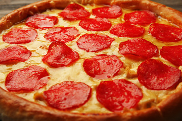 Tasty pizza with salami background, close up