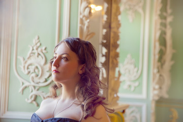 beautiful woman wearing corset posing in  palace