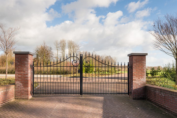 Locked iron gate of a new cemetery