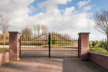 Fotobehang Locked iron gate of a new cemetery © Ruud Morijn