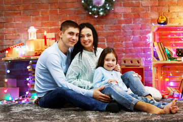 Happy family in the decorated Christmas room