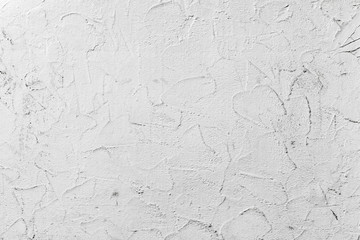 White concrete wall with decorative plaster pattern