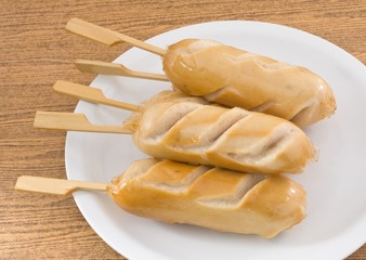 Stack of Cooked Sausages on A White Dish