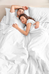 Obraz na płótnie Canvas Happy couple snoozing on bed