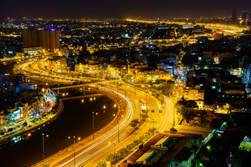 Fototapeta na wymiar Panoramic view of Vo Van Kiet highway, Ho Chi Minh city (or Saigon) by night, Vietnam. Saigon is the largest city and economic center in Vietnam with population around 10 million people.
