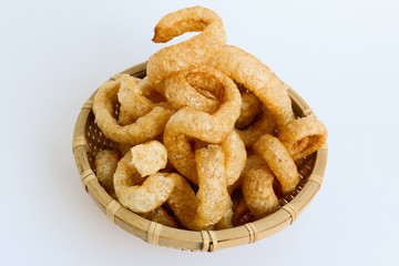 Crispy Pork Skin , Thai style food  in a wicker basket isolated over the white background 
