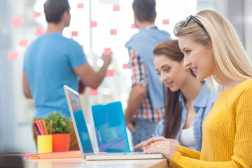 Skillful four colleagues are working with joy