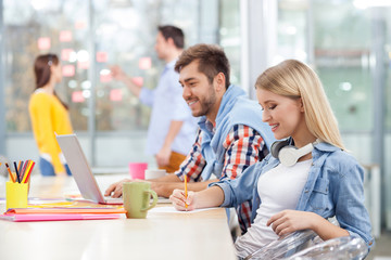 Cheerful creative team is discussing their work