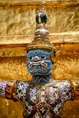 Close-up of demon guarding Golden Stupa at Wat Phra Kaeo in the Grand palace, Bangkok, Thailand