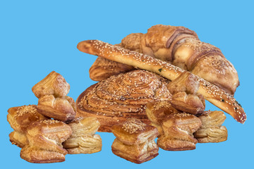 Bunch of Croissant Puff Pastry Sprinkled with Sesame Seeds, Isolated on Blue Background.