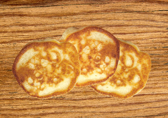 Sweet fritters on wooden table background