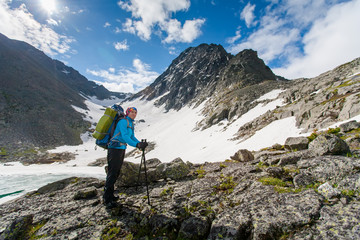 Naklejka premium Young woman is hiking in highlands of Altai mountains, Russia